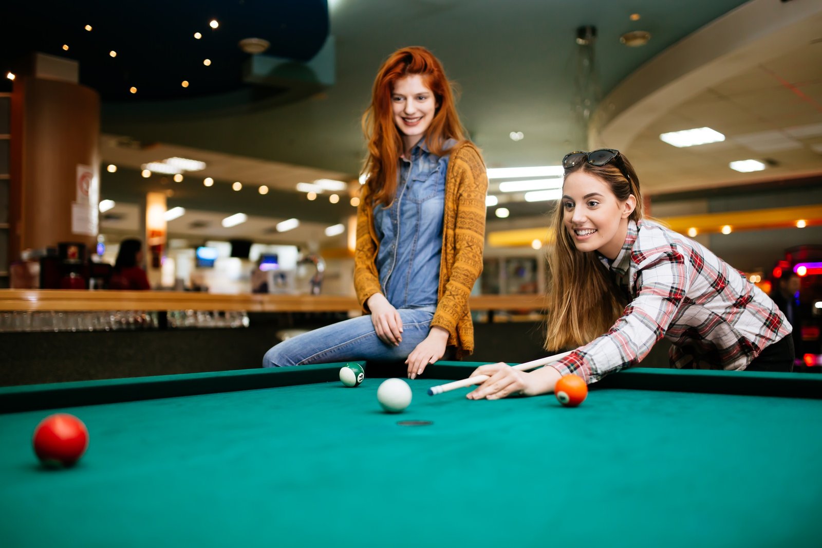 happy-young-friends-playing-snooker-and-billiards.jpg